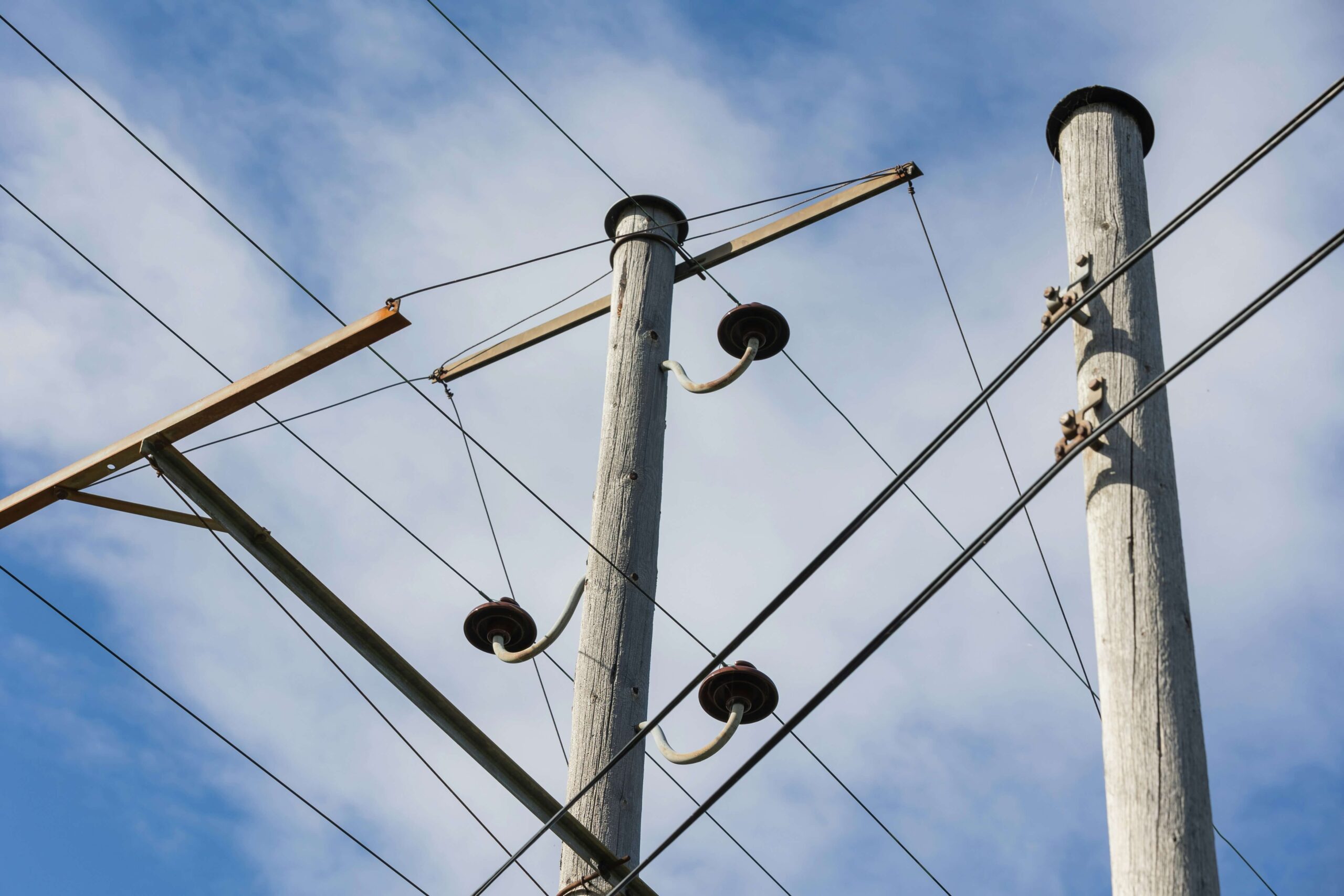 Power lines in front of a blue sky